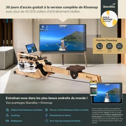 Holz-Rudergerät mit Wasserbehälter vor einem großen Fernseher, der ein Rudertraining zeigt. Smartphone und Tablet daneben.