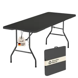 Faltbarer Tisch mit schwarzer Platte und stabilen Metallbeinen, beschriftet mit einem Etikett. Ein zusammenklappbares Modell ist sichtbar.
