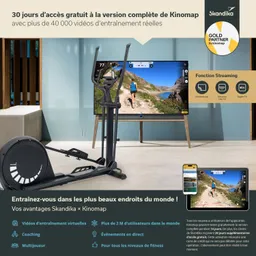 Ein Fitnessgerät steht im Vordergrund, im Hintergrund ist ein großer Bildschirm mit einer Trainingsvideoansicht sichtbar.