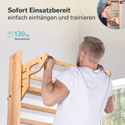 Holzgerät mit Riegeln wird an einer Wand montiert. Eine Person hält das Gerät mit beiden Händen und schaut nach oben.