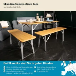 Campingtisch mit zwei Bänken und einer dekorierten Oberfläche, umgeben von einer Wohnlandschaft in einem Zelt.