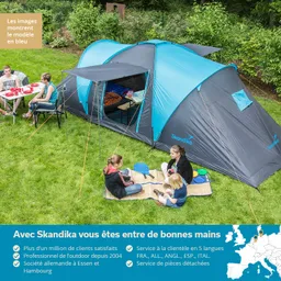Zelt in Blau und Grau auf einer Wiese, umgeben von Menschen, die am Boden sitzen und essen. Einige Prüfgeräte sind sichtbar.