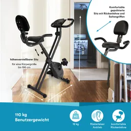 Faltbares Ergometer mit höhenverstellbarem Sitz, Rückenlehne und Seitengriffen, im Innenraum auf Holzfußboden platziert.