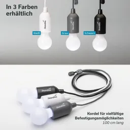 Drei Hängeleuchten in Weiß, Grau und Schwarz, jeweils mit Glühbirne, auf einem Tisch mit einer Kordel für Befestigungen.