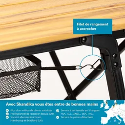 Holztisch mit einem Netz zum Aufhängen an einem metallischen Gestell. Text und Symbole in mehreren Sprachen sind sichtbar.