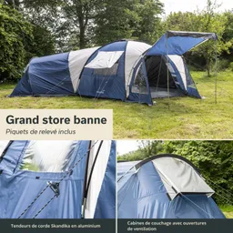 Blau-weißer Campingausleger mit Sichtfenstern, auf einer Wiese platziert. Grüne Bäume im Hintergrund.