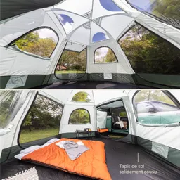 Innensicht eines Zeltes mit großen Fenstern, einem orangefarbenen Schlafsack und einem kleinen Tisch. Grünes Zeltmaterial und Natur außen sichtbar.