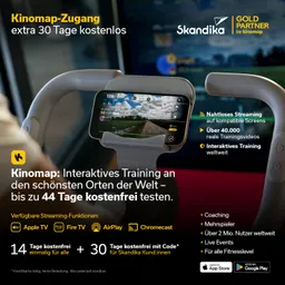 Person sitzt auf einem ergometrischen Fahrrad. Das Display zeigt verschiedene Funktionen. Im Hintergrund ist ein heller Raum mit Fenster und Pflanzen.