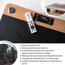 Vibrationsgerät mit Holz- und PU-Leder-Oberfläche. Fernbedienung und Bedienelemente mit digitalem Display sichtbar.