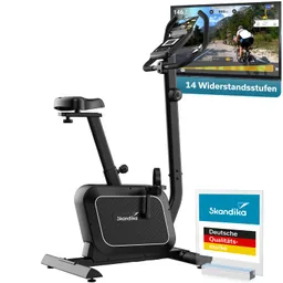 Stationäres Fahrrad mit Bildschirm für Trainingsdaten und 14 Widerstandsstufen. Logo von Skandika und Qualitätssiegel sichtbar.
