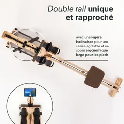 Rudergerät aus Holz mit doppeltem Schienensystem. Transparentes Wasserbehälter und ergonomische Fußstützen sind sichtbar.
