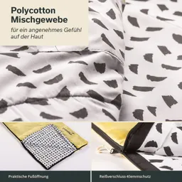 Mischgewebe in Schwarz-Weiß mit unregelmäßigen Mustern. Teil eines Schlafsacks mit gelber Innenseite. Reißverschluss und Fußöffnung sichtbar.