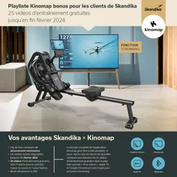 Rudergerät in modernem Design steht im Vordergrund, dahinter ein Fernseher zeigt Ruder-Statistiken. Informationen zu Skandika und Kinomap.