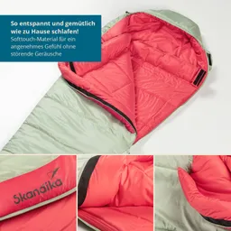 Schlafsack in Grün und Pink mit geöffnetem Reißverschluss. Innen liegt weiches Textilmaterial. Logo „Skandika“ sichtbar.