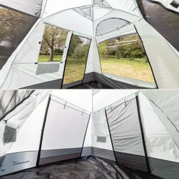 Zeltinnenansicht mit großen Fenstern, hellen Wänden und grauem Boden. Sicht auf Gras und Bäume draußen.