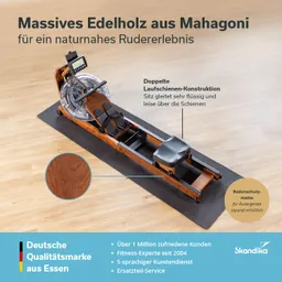 Rudergerät aus Mahagoni mit transparentem Wassertank und schwarzem Sitz. Auf einer Bodenmatte, helle Holzoberfläche im Hintergrund.