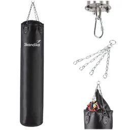 Schwarze Sandsack mit Kettenaufhängung und Haken, daneben eine obere Halterung und verschiedene Kettenteile.