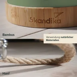 Bambusuntersetzer mit der Aufschrift "Skandika" und Hanfseil auf einem Holzuntergrund. Text über natürliche Materialien.