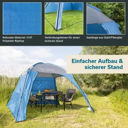 Ein blauer Pavillon steht auf einer Wiese, daneben ein Tisch mit Stühlen. Im Hintergrund sind Bäume und hohe Gräser sichtbar.