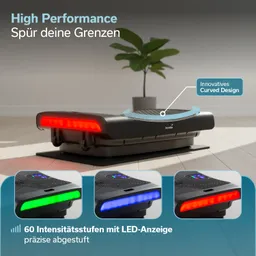 Vibrationsgerät mit LED-Anzeige in verschiedenen Farben, auf einem Untergrund platziert. Im Hintergrund eine Pflanze.