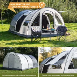 Ein Zelt steht auf einer Wiese, mit offenen Fenstern und Türen, umgeben von Stühlen und einem Tisch.
