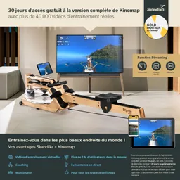Wasserrudergerät aus Holz steht in einem Raum neben einem Fernseher. Auf dem Bildschirm sind Grafiken und Trainingsdaten sichtbar.