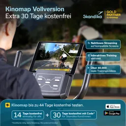 Ein Fitnessgerät mit Bildschirm zeigt ein Radfahrerlebnis auf einer Strecke. Tasten für Steuerung sind gut sichtbar. Text beschreibt kostenlose Testzeiträume und Streaming-Funktionen.