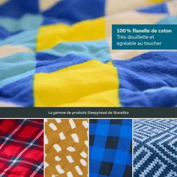 Bunt gemusterte Baumwollflanelle in Gelb, Blau und Creme, mit weiteren Stoffmustern in Rot, Braun und Blau.