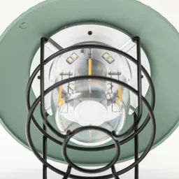 Lampe mit grünem Schirm, metallischer Basis und Glas-Leuchtelement, umgeben von einem schwarzen Schutzgitter.