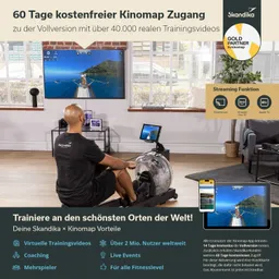 Ein Fitnessgerät zum Rudern steht in einem Raum mit Fensterlicht. Im Hintergrund ist ein Bildschirm mit einer Landschaftsaufnahme sichtbar. An einer Wand sind einige Bilder und Dekorationen.