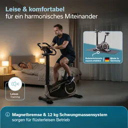 Ein Heimtrainer mit verstellbarem Sitz und Tablet-Halterung steht auf einem Teppich in einem Wohnraum mit Sofa und Pflanze.