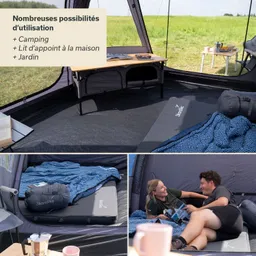 Zeltinneneinrichtung mit einem Bett und einer blauen Decke. Am Boden liegen Bücher, ein Tisch steht daneben. Zwei Personen sitzen entspannt.