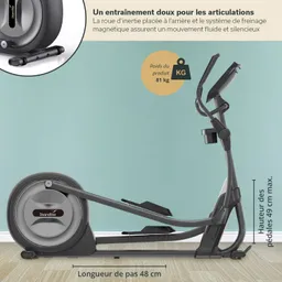Ein Crosstrainer in seitlicher Ansicht. Der Rahmen ist in dunklem Grau gehalten, mit einer großen Schwungscheibe hinten. Die Pedale sind sichtbar, und an der Vorderseite befindet sich ein Bedienfeld. Der Hintergrund ist in einem sanften Mintgrün gehalten.