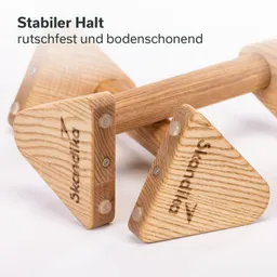 Holzhandgriff mit dreieckigen Enden, auf einem weißen Hintergrund. Beschriftung „Stabiler Halt, rutschfest und bodenschonend“.