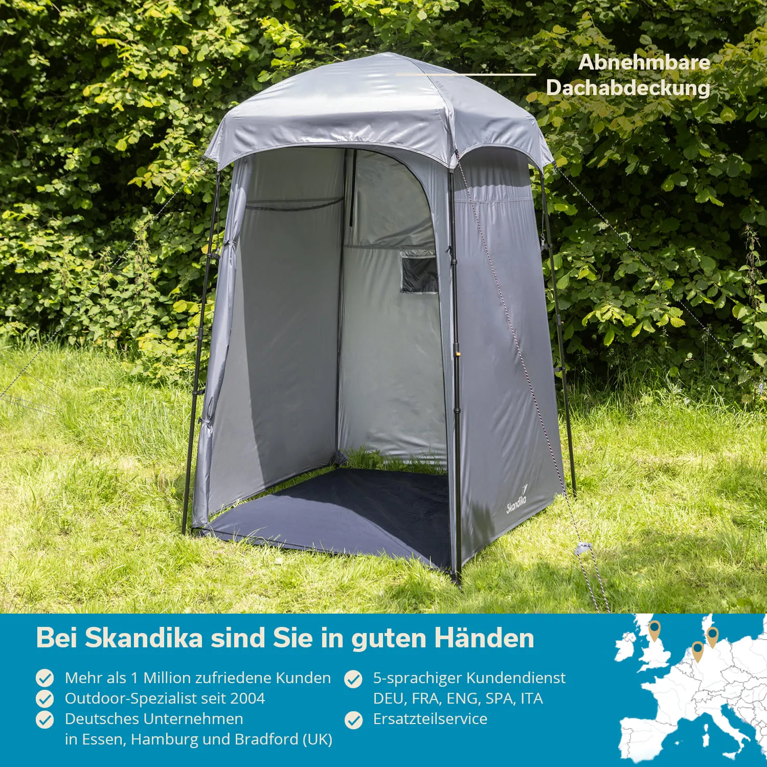 Grauer Campingraum mit abnehmbarer Dachabdeckung, auf Rasen zwischen Bäumen. Textinformationen unten.
