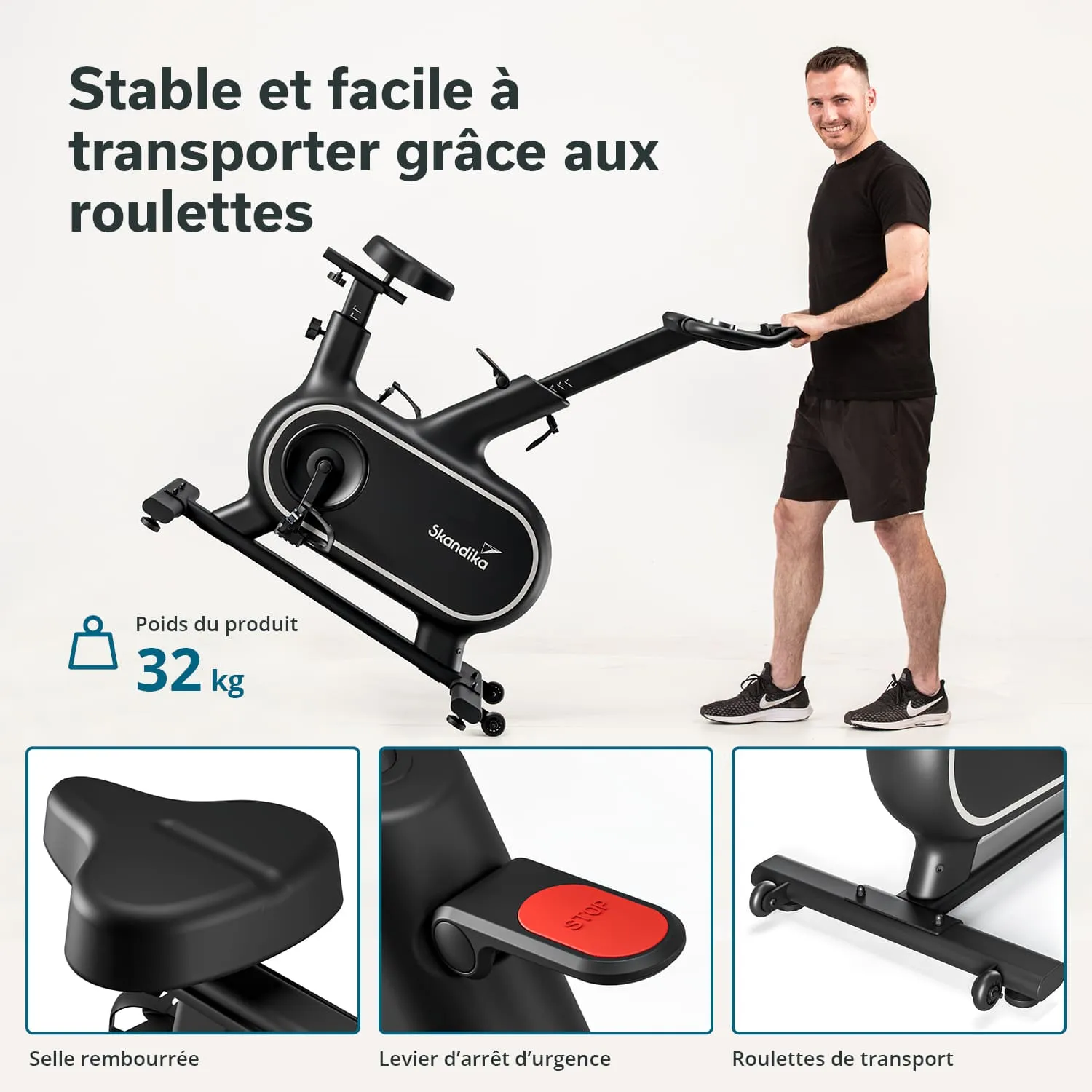Fahrrad Ergometer in schwarzer Farbe mit Transportrollen, neben einem lächelnden Mann in sportlicher Kleidung.