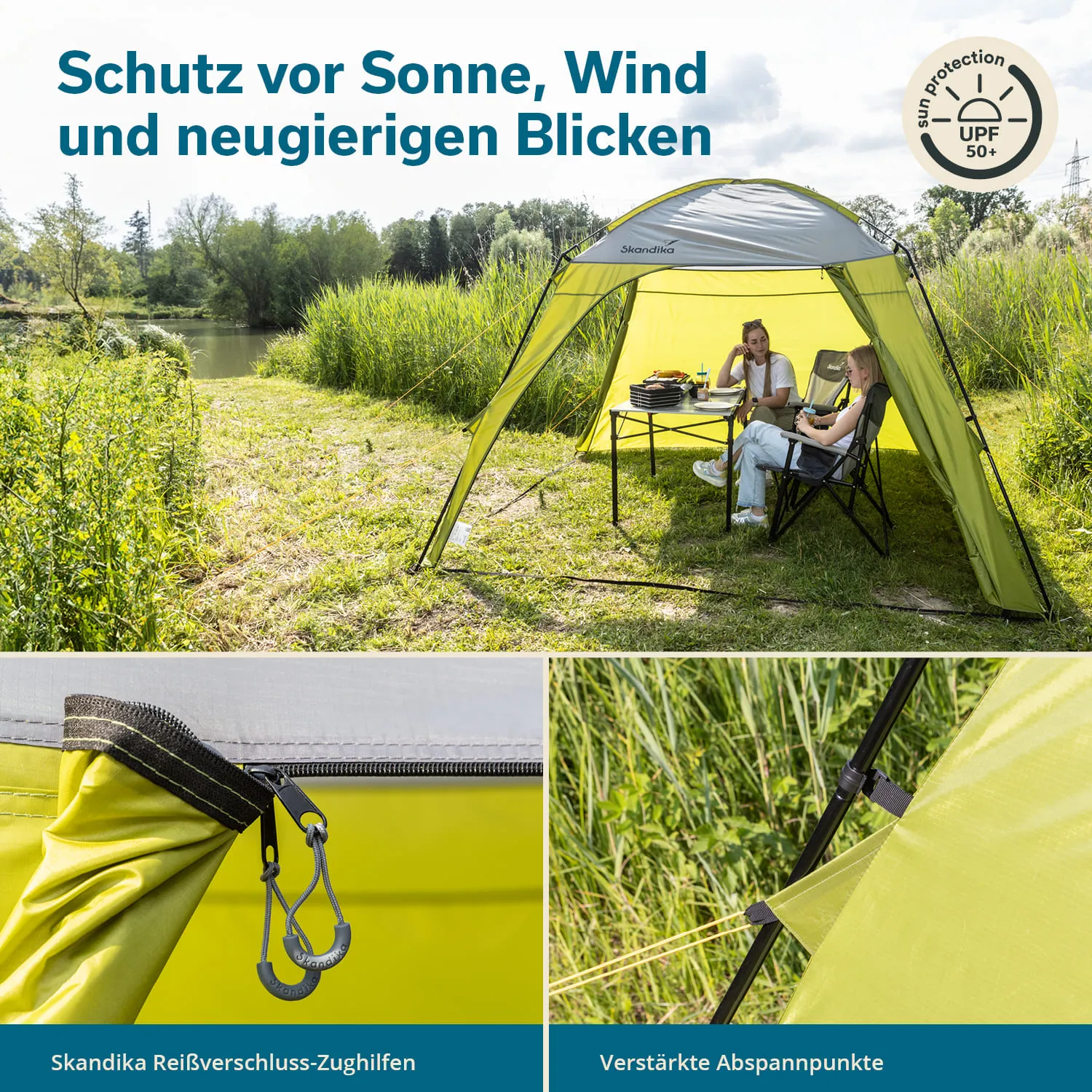 Zelt mit grünen Wänden auf einer Wiese am Wasser, zwei Personen sitzen an einem Tisch, mit Geschirr. Details des Zeltmaterials und -stabilität.