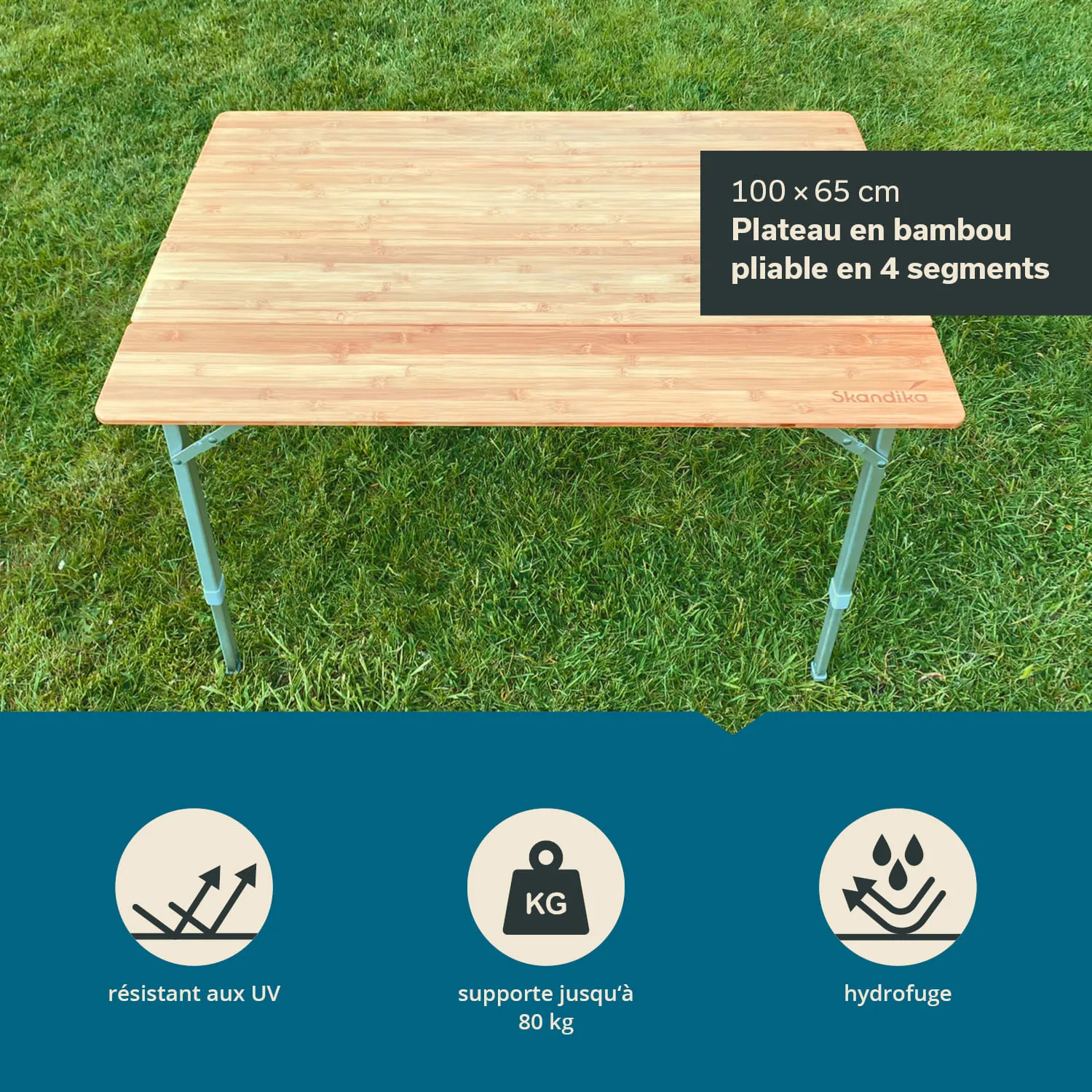 Faltbarer Tisch aus Bambus mit den Maßen 100 x 65 cm, auf grünem Gras platziert. Tischbeine aus Metall.