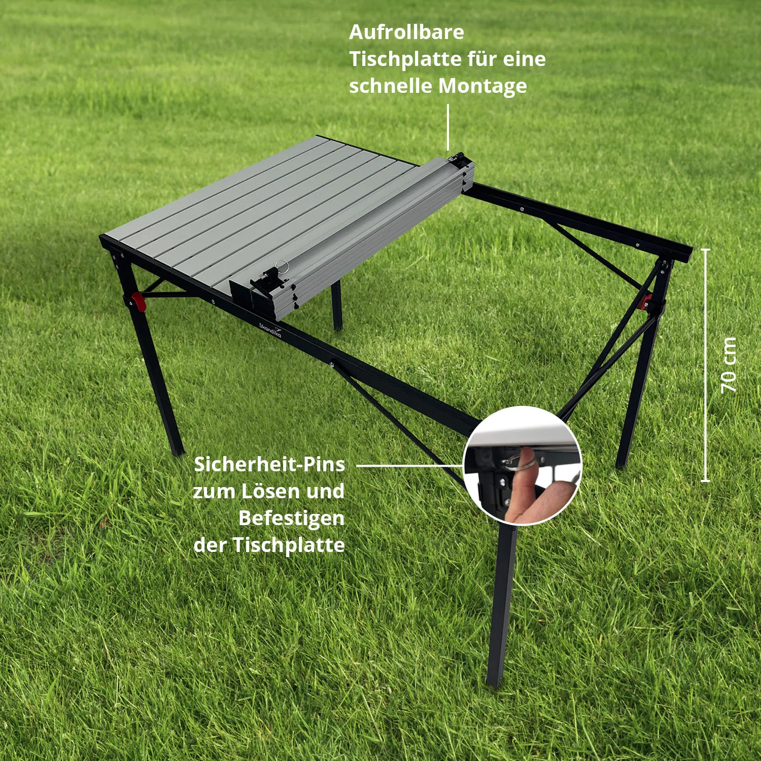 Tisch mit rollbarer Tischplatte und Sicherheits-Pins zur Montage auf grünem Gras. Maße: 70 cm hoch.