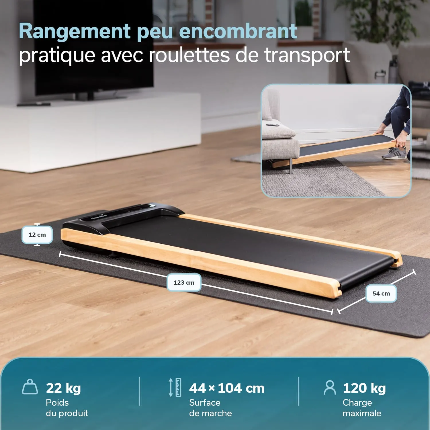 Laufband mit Holzrahmen, liegend auf einem Teppich. Maße und Gewichtsangaben sind sichtbar. Hintergrund zeigt einen Raum mit Fernseher.