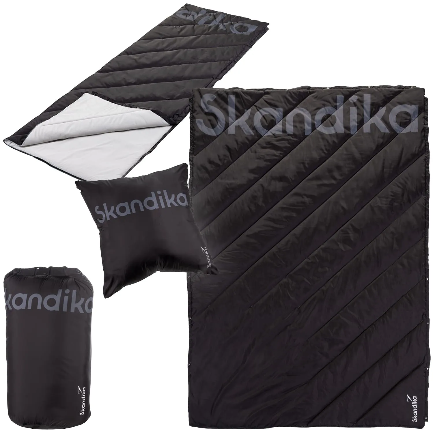 Schlafsack und Kissen in Schwarz mit diagonal verlaufenden Nähten. Schlafsack ist umgeschlagen, darunter helle Innenseite sichtbar.