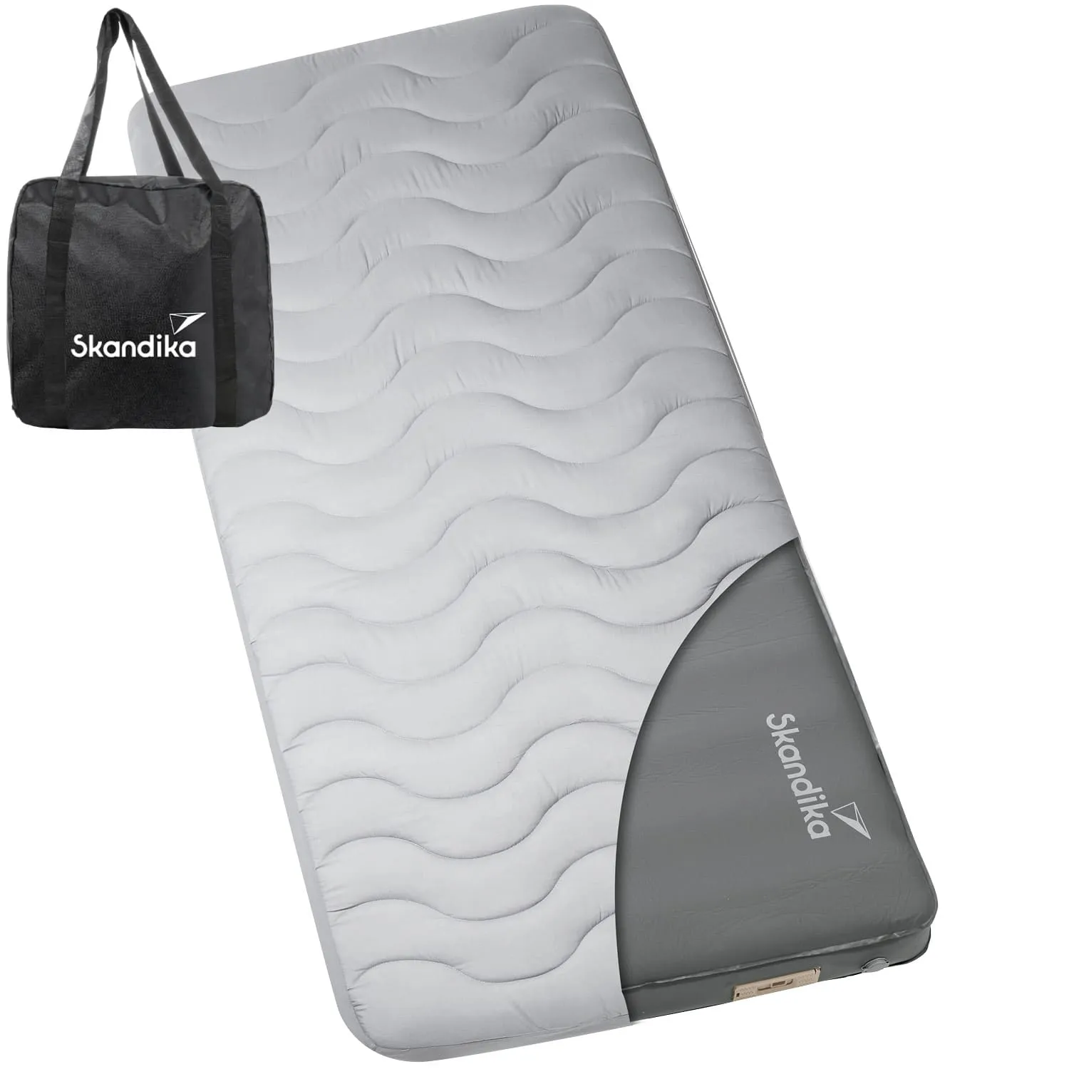 Eine graue Matratze mit gewelltem Design in einer weißen Tasche steht links im Bild. Auf der Matratze ist das Logo „Skandika“ sichtbar.