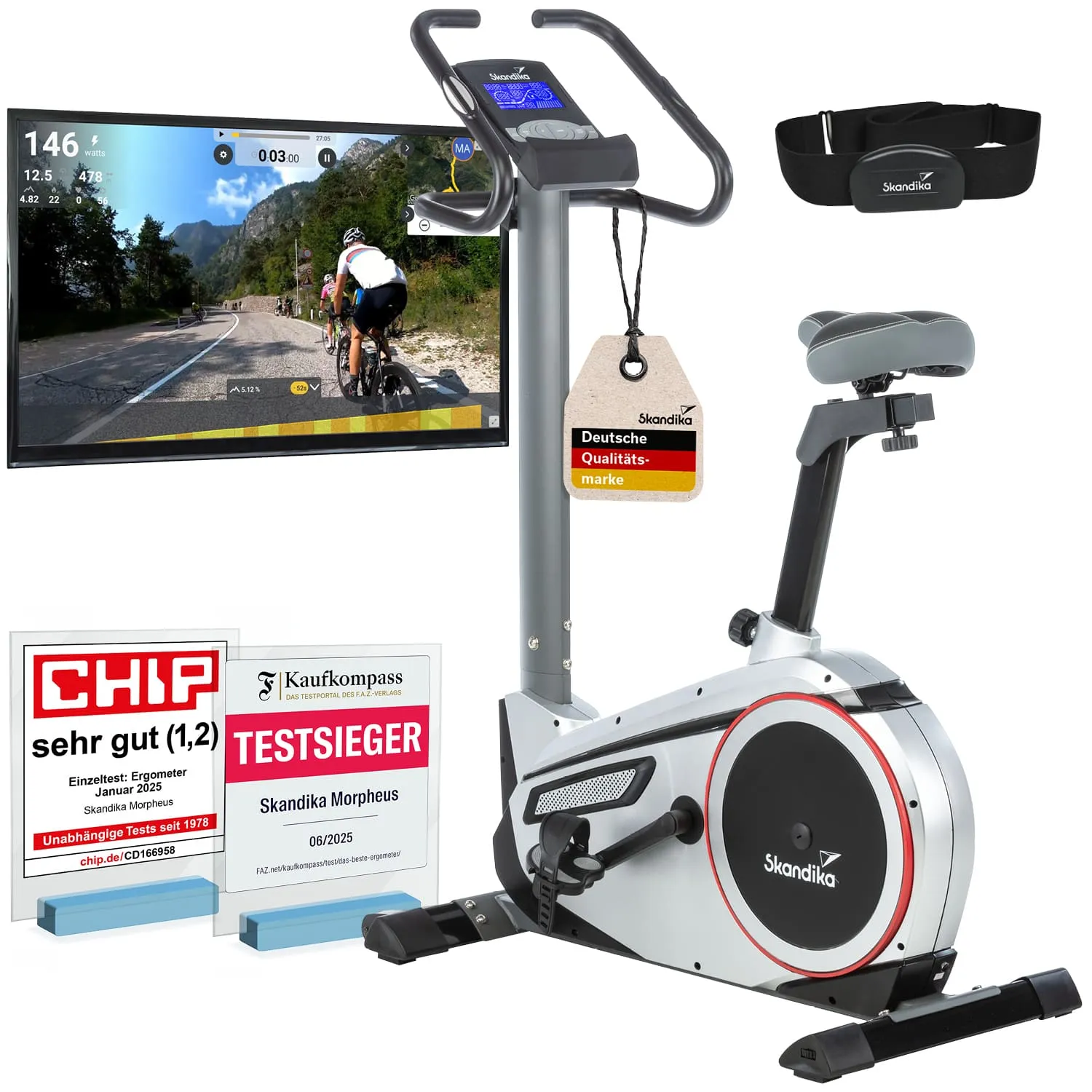 Ergometer in silberner Ausführung mit Bildschirm, Herzfrequenzgurt und mehreren Auszeichnungen im Vordergrund.