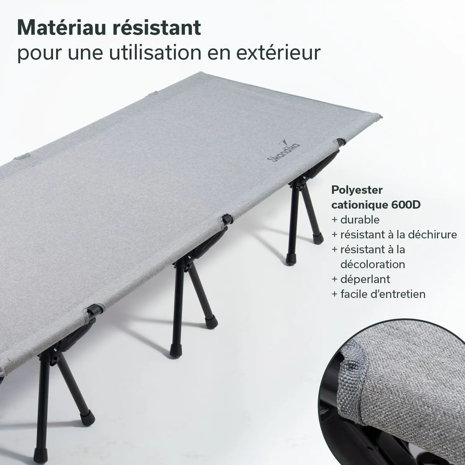 Liegematte mit grauem, strapazierfähigem Bezug und schwarzen, klappbaren Beinen. Text in mehreren Punkten zur Materialbeschreibung.