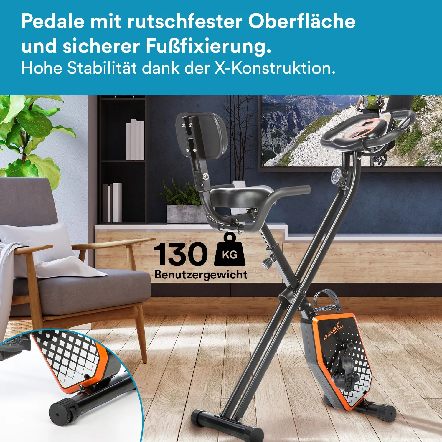 Fahrrad mit rutschfesten Pedalen, stabiler X-Konstruktion und einem Gewichtslimit von 130 kg. Im Hintergrund ein Wohnzimmer.