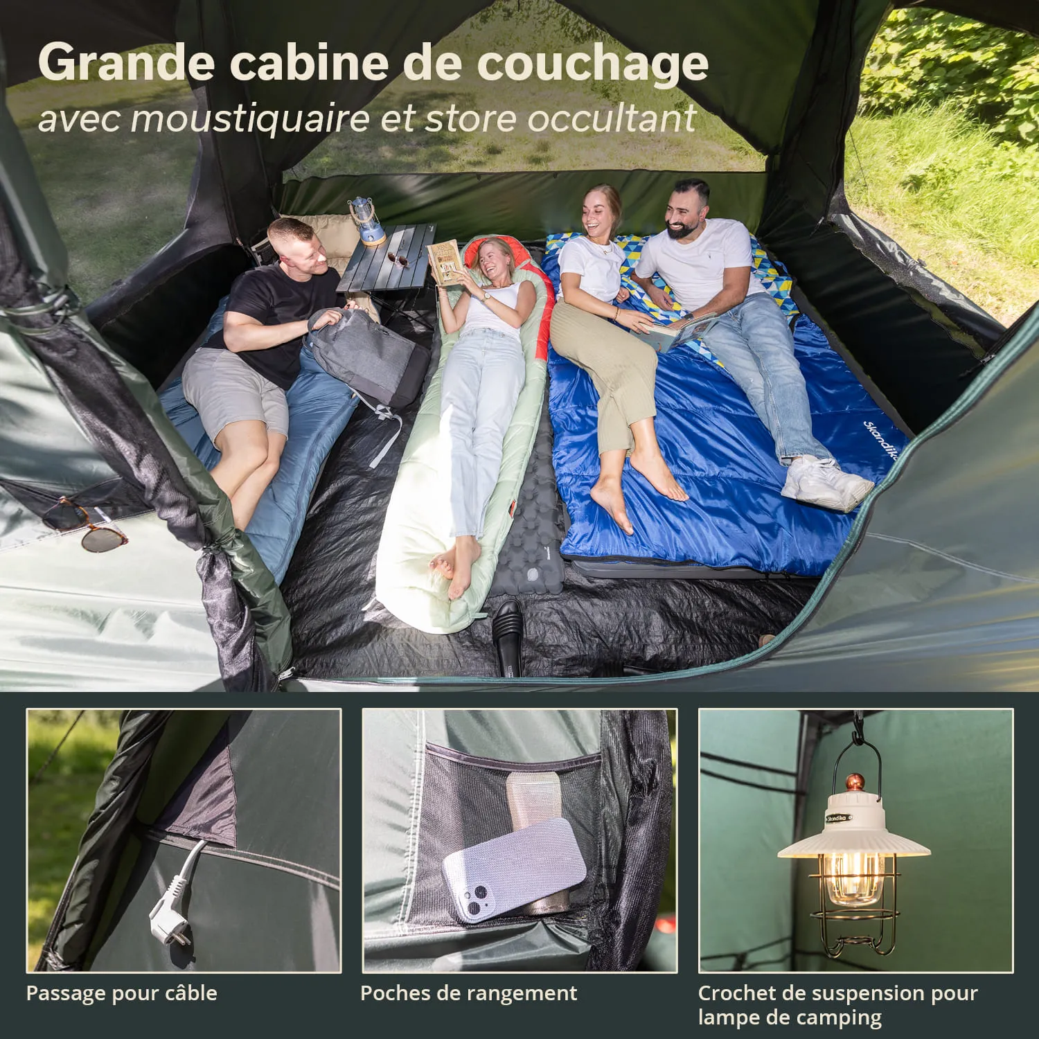 Innenseite eines großen Zeltbereichs mit mehreren Schlafmatten, Tischelement und dekorativer Campinglampe.