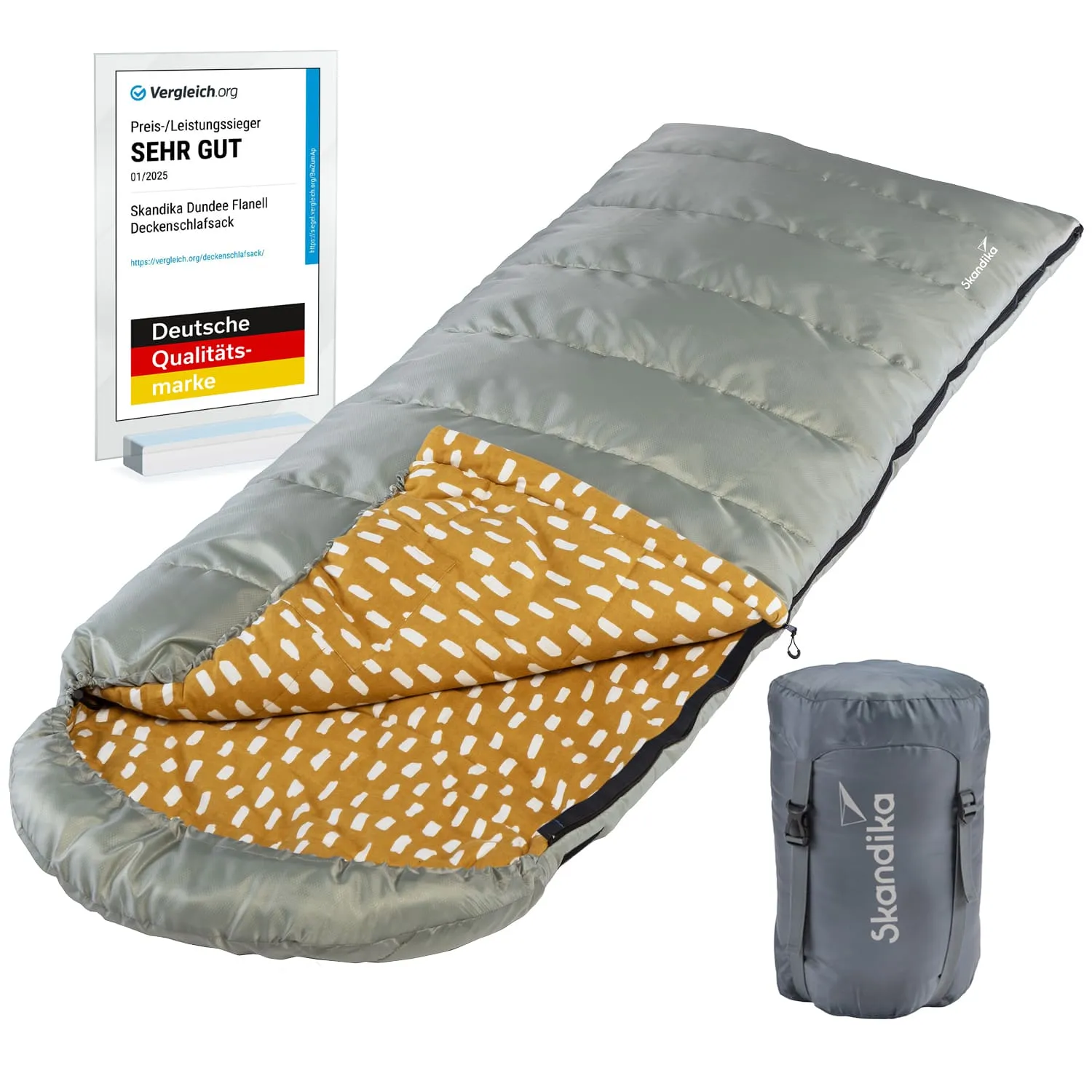 Ein grauer Schlafsack mit einer orangen Innenfläche mit Muster. Daneben steht eine Auszeichnung für "SEHR GUT" von Vergleich.org. Ein komprimierter Beutel ist ebenfalls sichtbar.