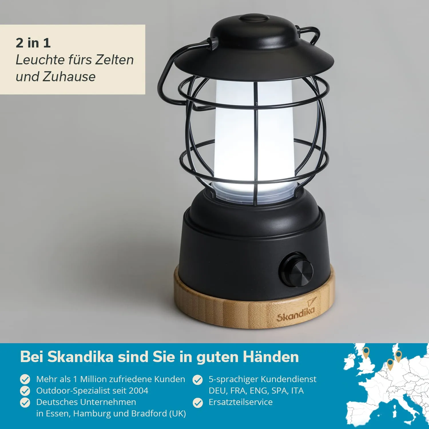 Schwarze Lampe mit Gitter und hellem Licht, Holzsockel. Text im Hintergrund: „2 in 1 Leuchte fürs Zelten und Zuhause“.