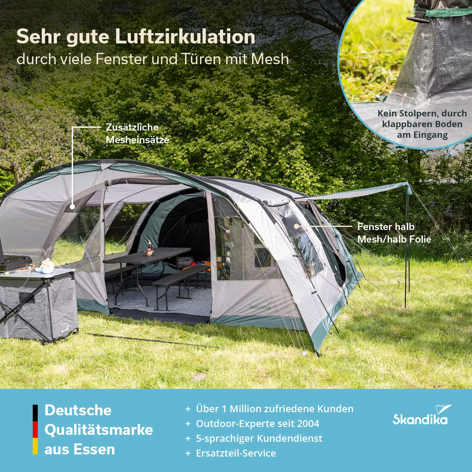 Zelt mit mehreren Fenstern und Türen, Tisch und Stühlen im Freien, umgeben von grüner Wiese und Bäumen.