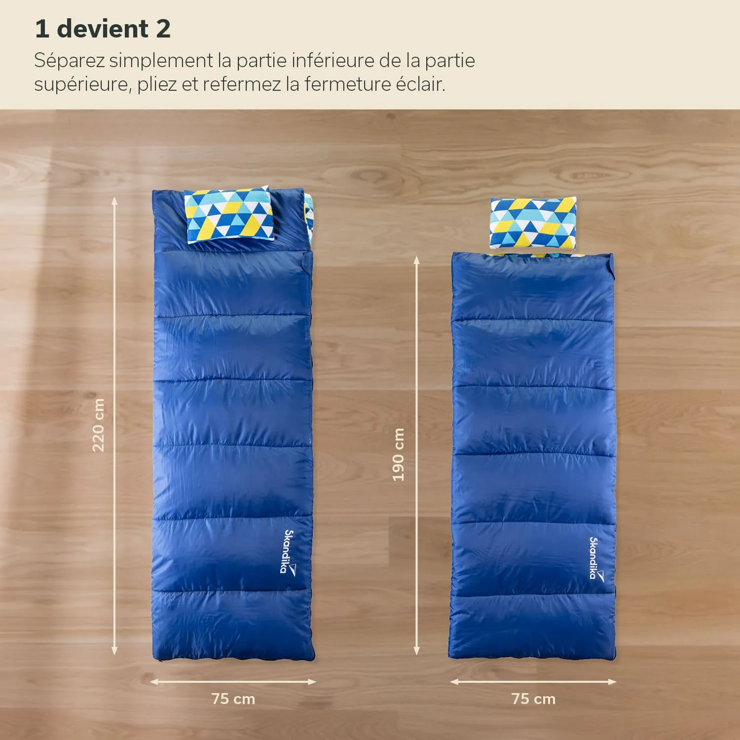 Zwei Schlafsäcke in Blau auf einem Holzuntergrund, einer 220 cm, der andere 190 cm lang, beide 75 cm breit. Kopfkissen mit buntem Muster.